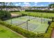 Aerial view of well-maintained community tennis courts surrounded by green space and lush landscaping at 1488 Croaton Crsg, Mount Pleasant, SC 29466