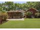 Charming backyard with screened porch, patio, and lush green lawn, perfect for outdoor entertaining at 1514 Gardenia Rd, Charleston, SC 29407