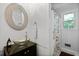 Cozy bathroom with glass vessel sink, decorative mirror, and shower with floral curtains at 1514 Gardenia Rd, Charleston, SC 29407