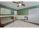 Charming Bedroom with a crib, decorative map, shaggy rug, and bright green wallpaper at 1514 Gardenia Rd, Charleston, SC 29407