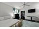 Bright bedroom with hardwood floors, a ceiling fan, a large window, and closet space at 1514 Gardenia Rd, Charleston, SC 29407