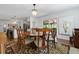 Elegant dining room with a wood table, chandelier, and access to a screened-in porch at 1514 Gardenia Rd, Charleston, SC 29407