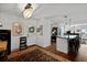 Inviting entryway with a decorative rug, chandelier, and view into the modern kitchen and dining spaces at 1514 Gardenia Rd, Charleston, SC 29407