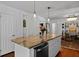 Charming kitchen island with granite countertop, seating, and stylish pendant lights above at 1514 Gardenia Rd, Charleston, SC 29407