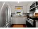Well-lit kitchen with stainless steel appliances, ample counter space, and classic white cabinetry at 1514 Gardenia Rd, Charleston, SC 29407