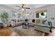 Cozy living room with a large sectional sofa, natural light, and a decorative rug over hardwood floors at 1514 Gardenia Rd, Charleston, SC 29407