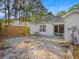 Fenced-in backyard with a gravel area, trees, and an outdoor patio at 1516 Blaze Ln, Charleston, SC 29412