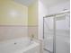 Clean bathroom showcasing a tub with tile surround and glass shower doors at 1516 Blaze Ln, Charleston, SC 29412