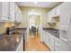Traditional kitchen featuring white cabinets, dark countertops, and stainless steel appliances at 1516 Blaze Ln, Charleston, SC 29412
