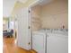 Convenient laundry room with washer, dryer, wire shelving, and wood flooring at 1516 Blaze Ln, Charleston, SC 29412