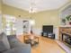 Cozy living room with a stone fireplace, plush sofa, and open access to the kitchen and hallway at 1516 Blaze Ln, Charleston, SC 29412