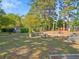 Community picnic area with tables, mature trees and landscaping, and visible tennis court at 1516 Blaze Ln, Charleston, SC 29412