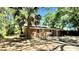 Brick home featuring an open yard, with large trees, and a covered patio at 1521 Camp Rd, Charleston, SC 29412