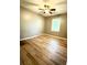 Bright bedroom with wood-look floors, window, and ceiling fan provides an inviting space at 1521 Camp Rd, Charleston, SC 29412