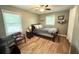 Well-lit bedroom featuring a bed, ceiling fan, wood flooring, and windows for lots of natural light at 1521 Camp Rd, Charleston, SC 29412