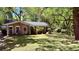 Charming brick home with mature trees and inviting front yard offering curb appeal at 1521 Camp Rd, Charleston, SC 29412