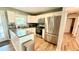 Modern kitchen with stainless steel appliances, granite countertops, white cabinetry, and a breakfast bar at 1521 Camp Rd, Charleston, SC 29412