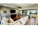 Spacious living room with hardwood floors, ceiling fan, mounted TV, and lots of natural light at 1521 Camp Rd, Charleston, SC 29412