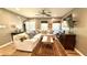 Inviting living room features a large sectional sofa, hardwood floors, and abundant natural light at 1521 Camp Rd, Charleston, SC 29412