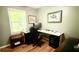 Cozy home office with ample desk space, natural light, and wood-look floors creates a productive atmosphere at 1521 Camp Rd, Charleston, SC 29412