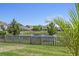 A serene backyard with a pond view, wooden fence, and a beautiful tree in the foreground at 1537 Fishbone Dr, Johns Island, SC 29455