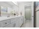 Bathroom featuring a double sink vanity, neutral walls, tile floors, and open doorway to the shower at 1537 Fishbone Dr, Johns Island, SC 29455