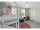Stylized bedroom featuring a bunk bed, large windows, and decorative accents at 1537 Fishbone Dr, Johns Island, SC 29455
