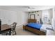 Bright bedroom featuring a blue bedspread, ceiling fan, dresser, and double door closets at 1537 Fishbone Dr, Johns Island, SC 29455