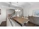 Elegant dining area featuring a modern chandelier and staircase in background at 1537 Fishbone Dr, Johns Island, SC 29455