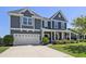 Charming two-story home with a well-maintained lawn and attached two-car garage at 1537 Fishbone Dr, Johns Island, SC 29455