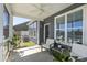 Relax on this cozy screened-in porch with a ceiling fan, comfortable seating, and beautiful outdoor views at 1537 Fishbone Dr, Johns Island, SC 29455