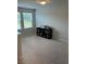 Carpeted bedroom features neutral walls, two windows, and a black bookshelf with decor at 167 Cypress Plantation Rd, Moncks Corner, SC 29461
