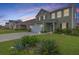 Charming two-story home with attached garage and manicured lawn at sunset at 167 Cypress Plantation Rd, Moncks Corner, SC 29461