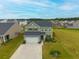 Aerial view of a two-story home with attached garage and manicured lawn at 167 Cypress Plantation Rd, Moncks Corner, SC 29461
