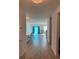 Inviting hallway showcasing modern wood flooring, with views of the kitchen and living areas bathed in natural light at 167 Cypress Plantation Rd, Moncks Corner, SC 29461