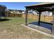 Covered patio overlooks a manicured lawn, wooden fence, and several houses in the distance at 167 Cypress Plantation Rd, Moncks Corner, SC 29461