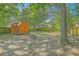 Backyard featuring a large shed, with many trees at 184 Tabby Creek Cir, Summerville, SC 29486
