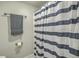 Bathroom featuring a towel rack, toilet paper holder, and a stylish blue-striped shower curtain at 184 Tabby Creek Cir, Summerville, SC 29486