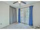 Bright bedroom featuring double doors that open to the backyard, and full privacy curtains at 184 Tabby Creek Cir, Summerville, SC 29486