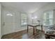 Bright dining room with wood floors, a tall lamp, and two windows with views of the neighborhood at 184 Tabby Creek Cir, Summerville, SC 29486