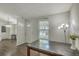 This dining room has wood floors, a view into the kitchen, and a door with decorative glass at 184 Tabby Creek Cir, Summerville, SC 29486
