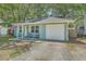 Charming light blue single story home with a one car garage and rocking chairs on the front porch at 184 Tabby Creek Cir, Summerville, SC 29486