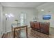 Cozy living room with a fireplace, TV, wood floors, and view into the dining area at 184 Tabby Creek Cir, Summerville, SC 29486