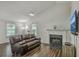 A warm living room features a fireplace, TV, and plush couch, perfect for relaxing at 184 Tabby Creek Cir, Summerville, SC 29486