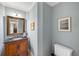 Powder room featuring wood vanity with dark granite countertop and light-blue walls at 1855 Cherokee Rose Cir, Mount Pleasant, SC 29466