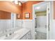 Bathroom featuring stylish vanity with modern fixtures and a view of the bathtub and shower area at 1855 Cherokee Rose Cir, Mount Pleasant, SC 29466
