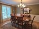 Elegant dining room featuring a chandelier and a large window with plantation shutters at 1855 Cherokee Rose Cir, Mount Pleasant, SC 29466