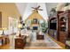 Bright living room featuring a fireplace, soaring ceilings, and large windows at 1855 Cherokee Rose Cir, Mount Pleasant, SC 29466