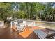 Back porch deck with a glass table, patio chairs, a grill, and a lounge chair overlooking a lawn at 1855 Cherokee Rose Cir, Mount Pleasant, SC 29466