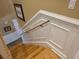 Staircase featuring wooden steps and white wainscoting, adding a touch of elegance to the home at 1855 Cherokee Rose Cir, Mount Pleasant, SC 29466